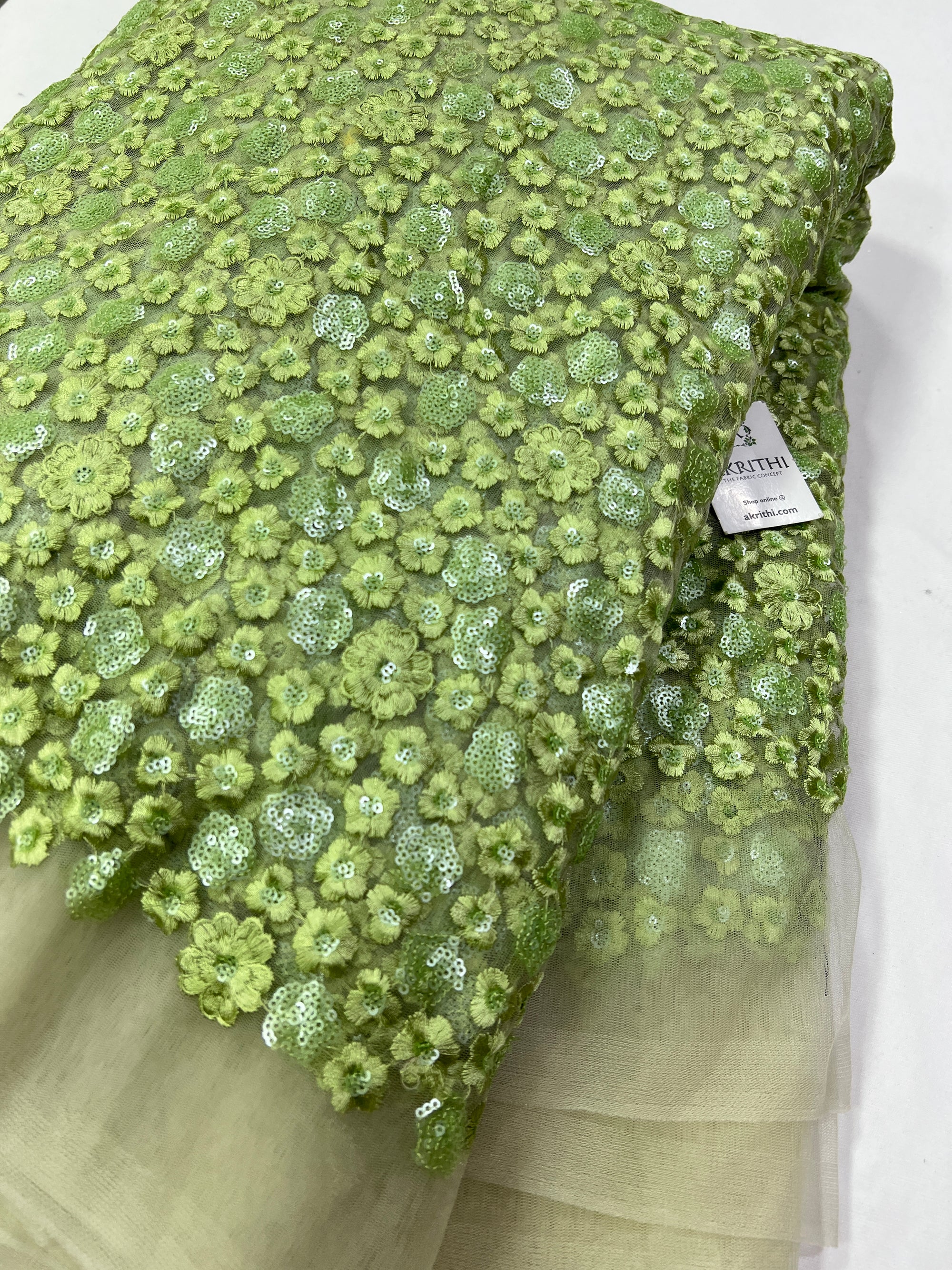 Green heavy Embroidery on Half white net fabric